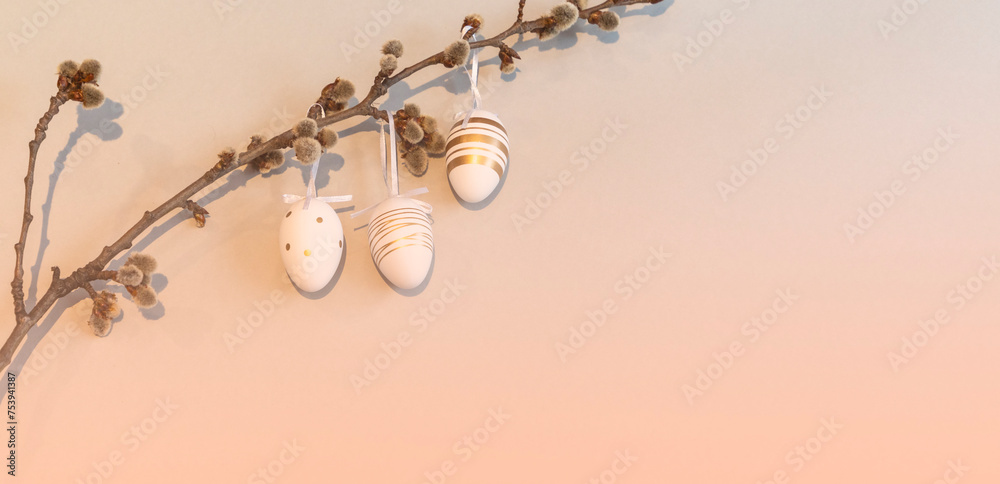 Fototapeta premium Easter eggs decorate a willow branch. Happy easter concept