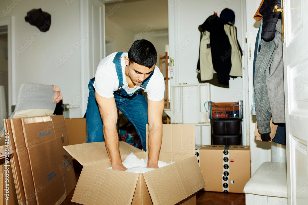 Man packs things into a box Man packs things into a box