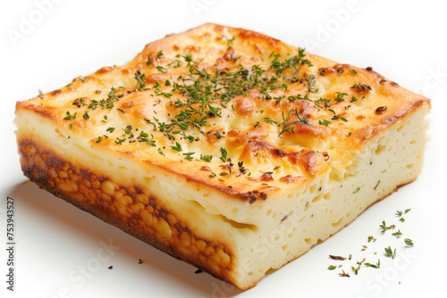 An image showcasing a delicious serving of cottage cheese casserole. The dish is garnished with fresh greenery and presented on a white background.