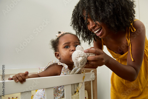 A mother playing with the baby to help her sleep photo