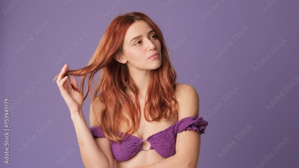 Pensive girl dreams on purple background in studio Pensive girl dreams on purple background in studio