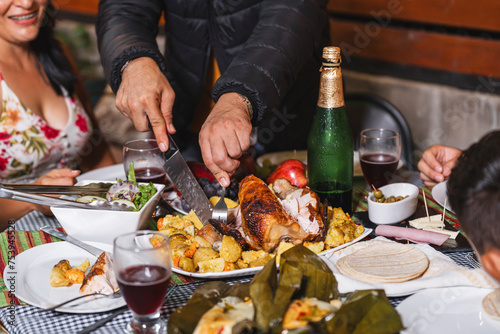 Unrecognizable man cutting up dinner chicken  photo