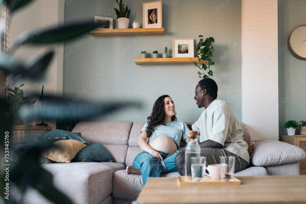 Happy Pregnant Couple Talking At Home Happy Pregnant Couple Talking At Home