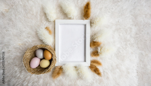 Easter decorations on the beige background/blank white frame/shot from above
