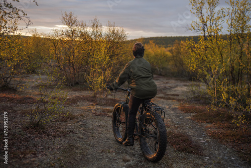 Woman bikepacking on a fatbike through tundra wilderness in arctic  photo