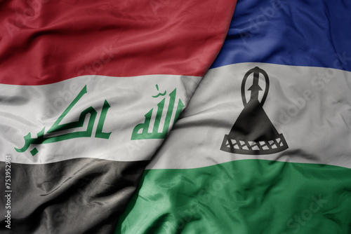big waving national colorful flag of lesotho and national flag of iraq.