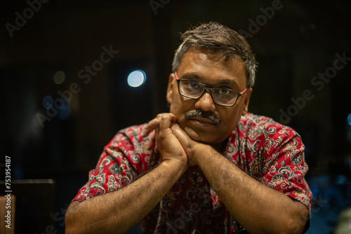 Portrait of a middle aged Indian man wearing colorful designer shirt photo