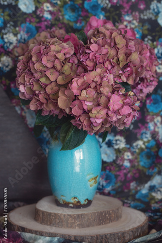 Beautiful purple hydrangea flowers in a vase on a table.Delicate floral arrangement. Close-up floral composition with a pink spring flowers. Soft focus.
