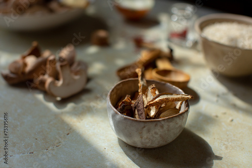 A small bowl of dried shiitake mushrooms among other ingredients photo