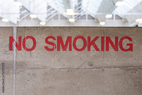 A hand-painted no smoking sign in a large building photo