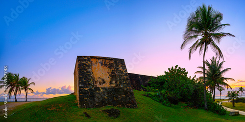 Palm Trees along the curving each trail at Sunrise in San Juan, Puerto Rico, Tranquil seascape on La Poza del Escambrón Beach over Condado Shore photo