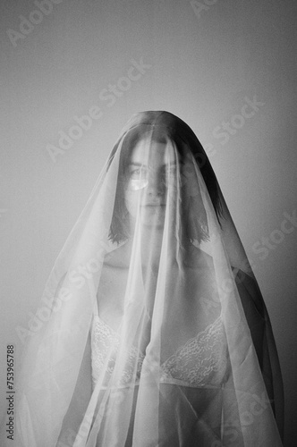 Young woman covered with veil photo