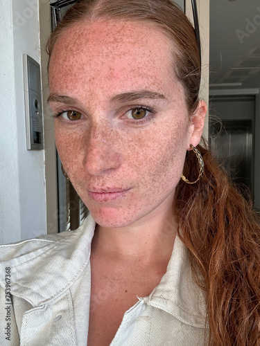 Real selfie of seren freckled woman photo