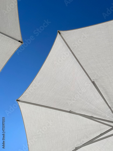 Blue Summer Sky and White Parasols