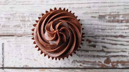 chocolate cupcake with chocolate butter cream swirl on white wooden background,