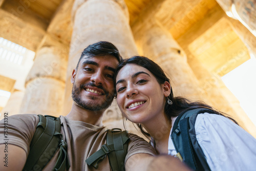 Couple taking a selfie at the Karnak Temple in Egypt. photo