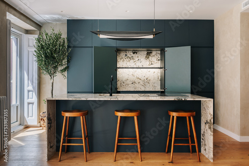 Modern Kitchen with dark green cabinetry and marble kitchen island  photo