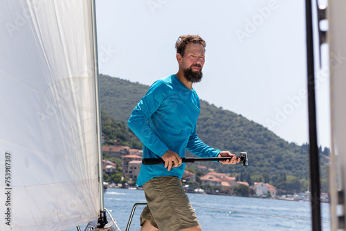 Sailor with underwater camera on yacht deck