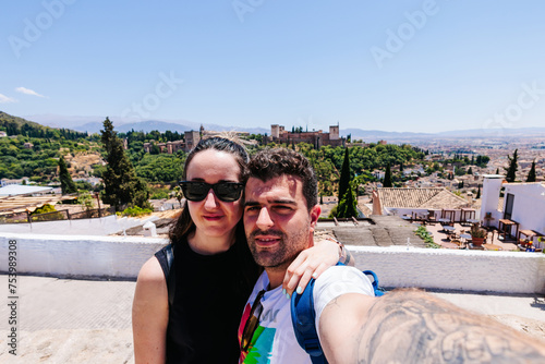 cheerful traveler couple with Alhambra monument in the background  photo