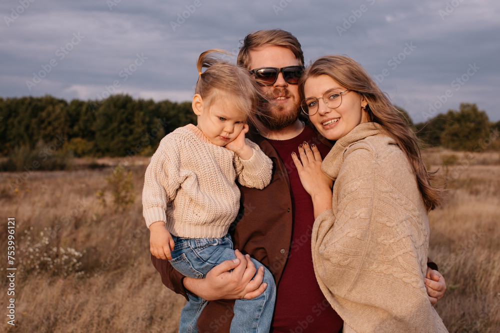 Young stylish family with daughter outdoors Young stylish family with daughter outdoors