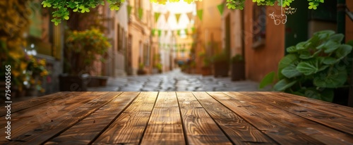 Early morning light bathes a picturesque, cobblestone street decorated with festive green shamrocks and bunting, as seen over an aged wooden tabletop. photo