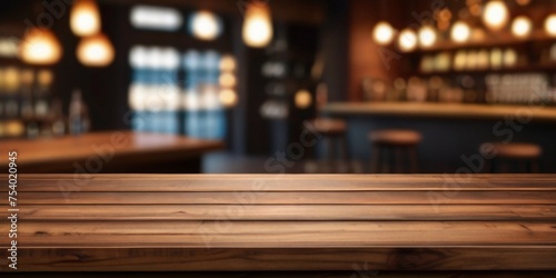 Rustic empty wooden table top of bar counter liquor store with copy space for your decoration. Vintage pub interior, Restaurant space. Abstract blurred bar background for product placement © MadeByAnas