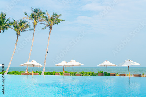 umbrella with bed pool around swimming pool with ocean sea background