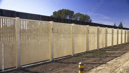 The Border Wall at the Arizona and Mexico border has two fences, one with barbed wire. photo