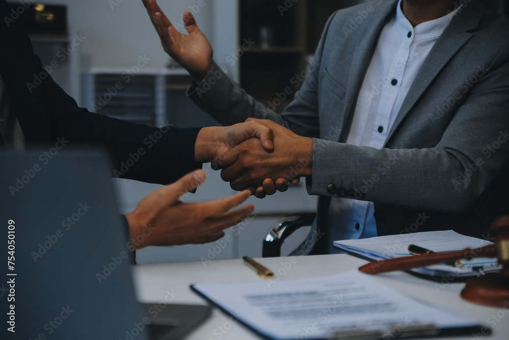 © ARMMY PICCA - Consultation and conference of Male lawyers and professional businesswoman working and discussion having at law firm in office. Concepts of law, Judge gavel with scales of justice.