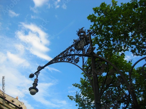 Canvastavla Beautiful street light silhouette and Casa Mila by Antoni Gaudi under the blue s