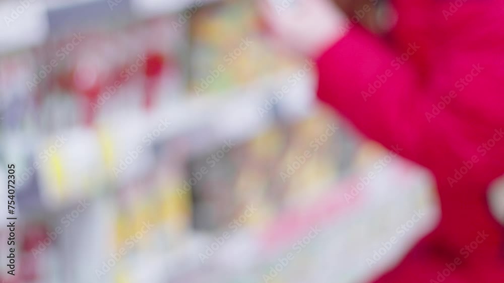 Blurry Woman in Red Jacket at Grocery Store. Selective focus Blurry Woman in Red Jacket at Grocery Store. Selective focus