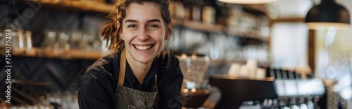 Beautiful female barista and smiles while working behind the bar counter in a cafe.