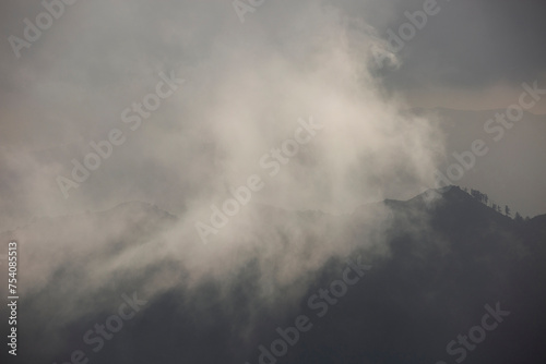 Afternoon fog rolls through the San Gabriel Mountains in Mount Wilson, California, USA.