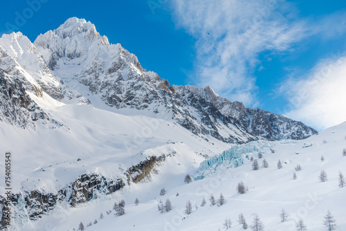 Mountains nearby Argentier Glacier in Chamonix France in winter. A view from ski area in Argentier ski resort to the Argentier Glacier. Beautiful view to blue end of glacier.