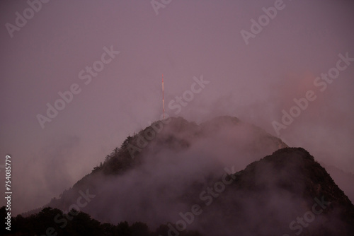 Foggy sunset view of Mt. Lowe on the Eaton Saddle Trail in the San Gabriel Mountains of Mount Wilson, California, USA.