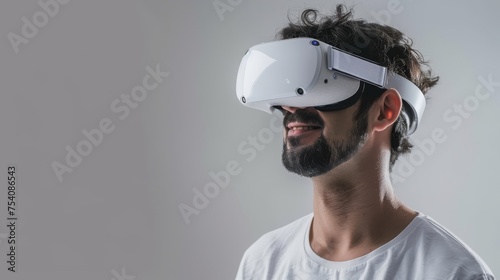 Smiling man on a white background while looking through a VR headset and making expressive gestures