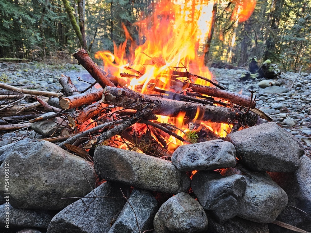 Flames from wood fire in the campground in a fire pit made from rocks in the forests of Washington State Flames from wood fire in the campground in a fire pit made from rocks in the forests of Washington State