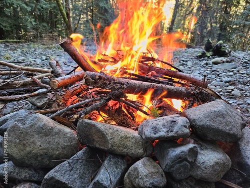 Flames from wood fire in the campground in a fire pit made from rocks in the forests of Washington State