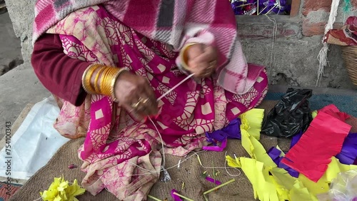 A woman preparing Mouri paper flowers head band used in Bihari wedding photo