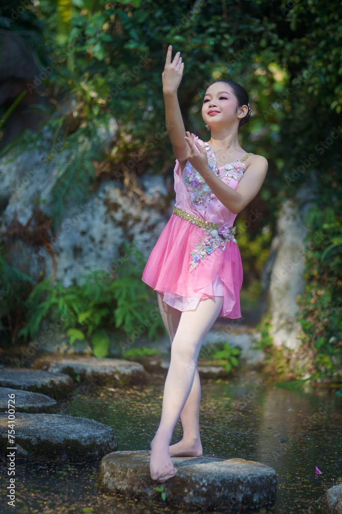 Beautiful girl ballerina dancing. Ballerina Project Show in the nature. A girl poses as a ballet performer in the green natural park. She was posting relax, and happiness. Beautiful girl ballerina dancing. Ballerina Project Show in the nature. A girl poses as a ballet performer in the green natural park. She was posting relax, and happiness.