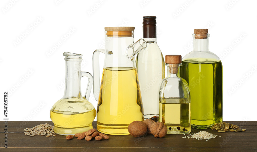 Vegetable fats. Different cooking oils and ingredients on wooden table against white background Vegetable fats. Different cooking oils and ingredients on wooden table against white background