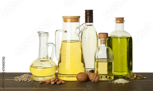 Vegetable fats. Different cooking oils and ingredients on wooden table against white background