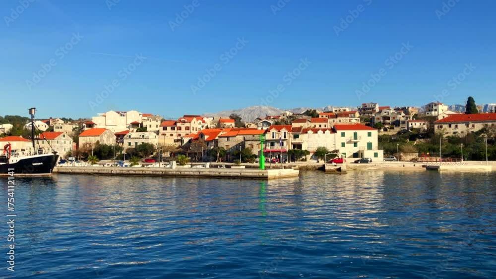 View of Port Sumartin and the Church of St. Martin. Seaside town. Coastal town of Sumartin. Brac Island, Croatia. Europe. View of Port Sumartin and the Church of St. Martin. Seaside town. Coastal town of Sumartin. Brac Island, Croatia. Europe.