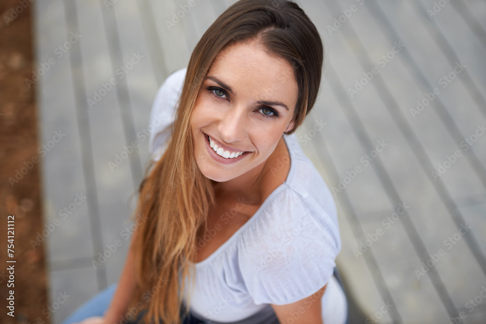Portrait, young woman or happy in outdoor in city, relax or travel adventure for wellness on holiday. French person, face or smile in urban town on summer vacation, above or satisfaction in france