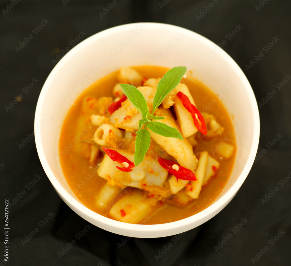Top view. Selective focus. Cumi Rica Rica, squid cuisine with red and spicy sambal. Indonesian food.
Top view. Selective focus. Cumi Rica Rica, squid cuisine with red and spicy sambal. Indonesian food.