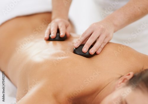 Картината върху платно Relax, hot stone massage and woman with therapist at spa for health, wellness and luxury holistic treatment