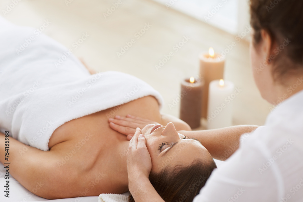Woman, massage and physical therapy or relax spa treatment at holiday resort or luxury care, service or stress relief. Female person, masseuse and candles for calm vacation, comfortable or skincare