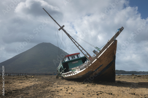 Shipwreck at low tide at the coast of Banda islands in Maluku district in Indonesia photo