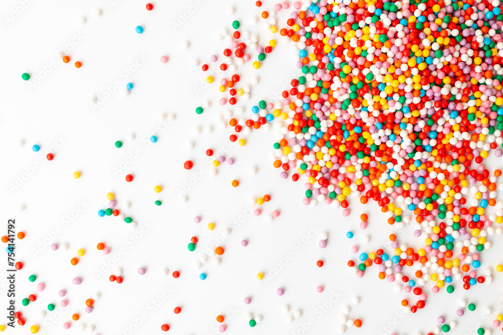 Colorful confectionery sprinkles on white background. Decoration for cake and bakery. Top view 