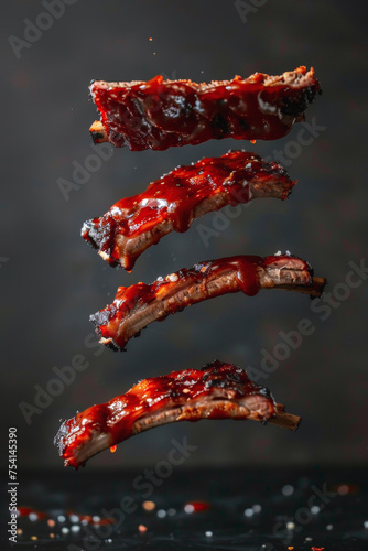 delicious BBQ Ribs - Pork or beef ribs cooked and coated in barbecue sauce floating in the air